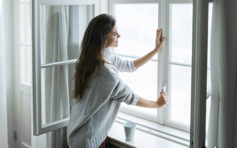 Woman opening a window